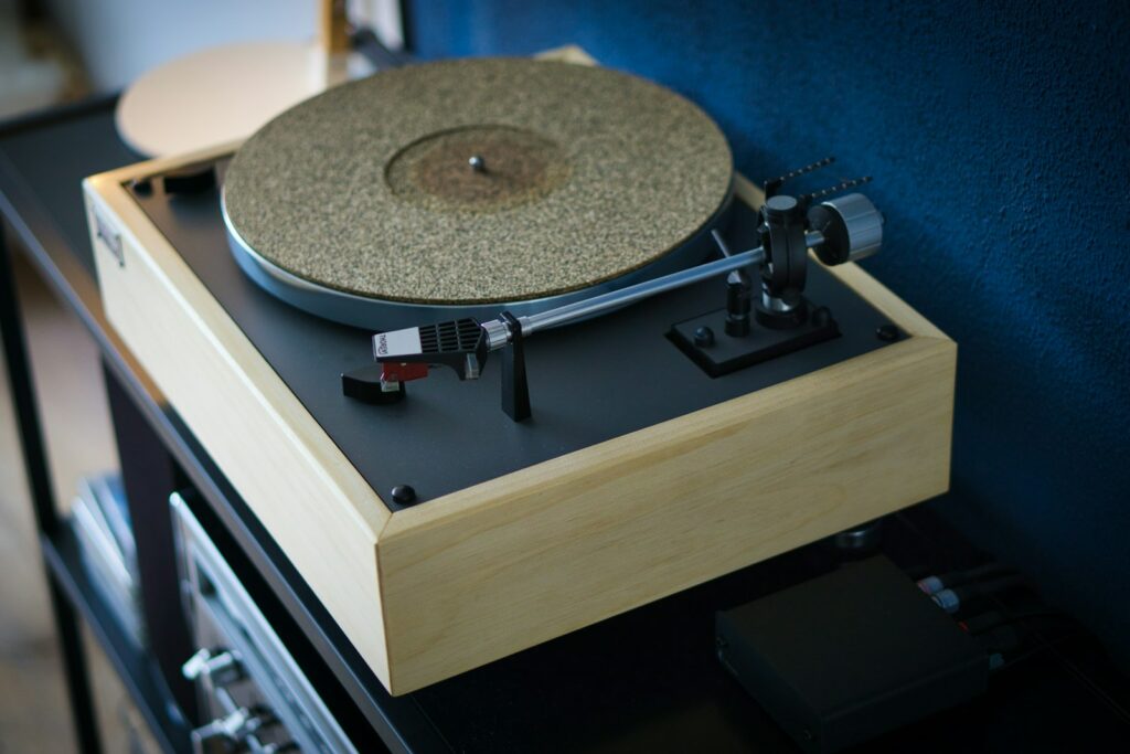 beige turntable on black wooden table